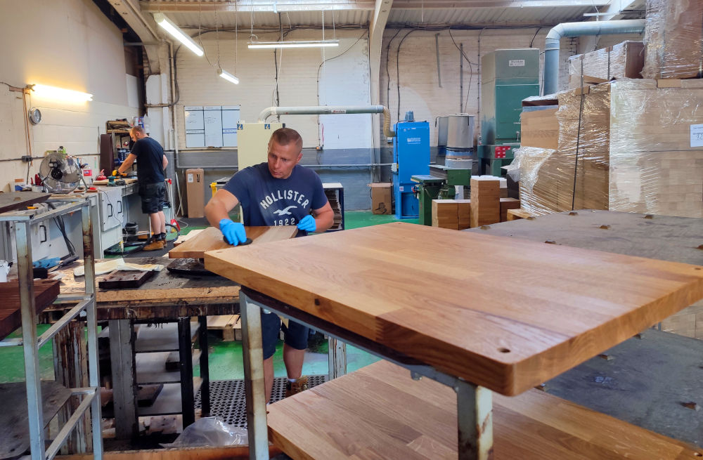 Atacama hi-fi rack shelves being sanded and stained after CNC machining